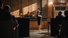 Court Of Justice And Law Trial: Successful Female Prosecutor Presenting The Case, Making Passionate Speech To Judge, Jury. Attorney Lawyer Protecting Client With Closing Not Guilty Arguments.