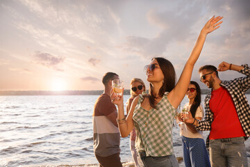 Canvas Print - Woman with friends having fun near river at summer party