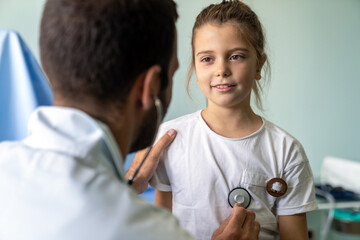 Wall Mural - Pediatrician doctor examining little girl in a clinic