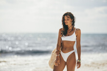 Tanned Woman In White Bikini On The Summer Beach
