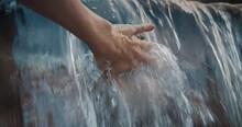 Close Up Soft Movement Of Female Hand Touches The Water In Waterfall. Calm On The Fresh Air With Water Drops On National Park. Clear And Pure Nature Feeling Good.