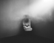 Scary Ghost Girl Sitting In Foggy Haunted Corner Of House