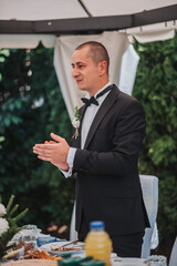 Canvas Print - Vertical shot of a groom  during the wedding