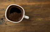 Fototapeta Mapy - Top view of coffee cup on a wood background with copy space.