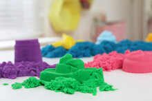 Colorful Kinetic Sand On White Table Indoors