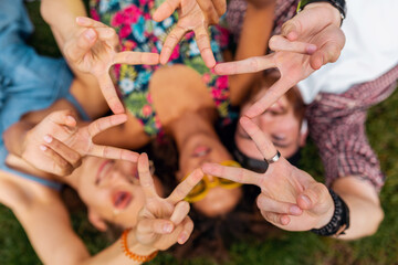 Wall Mural - happy young company of friends sitting park