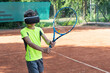 © Anna - Boy in virtua; reality glasses with racket in his hands is practicing playing tennis with virtual trainer. New technologies for sport