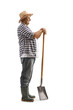 Full length profile shot of a mature farmer standing with a shovel