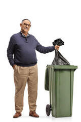 Poster - Mature man standing next to a waste bin and throwing a plastic bag inside