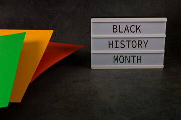 Black History Month. Red, yellow and green color paper on the black background. Copy space.