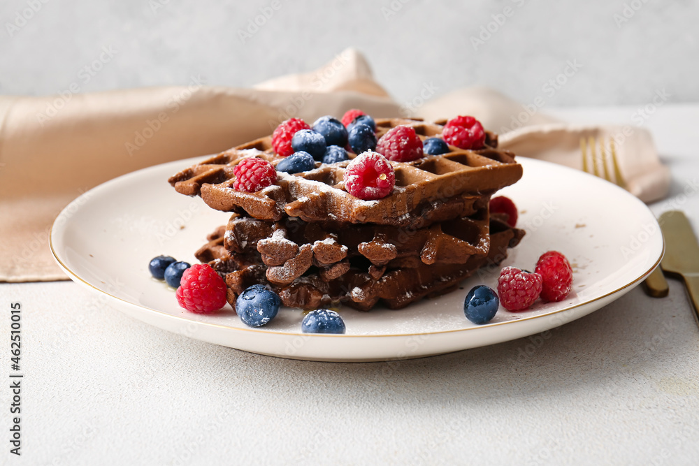 Plate of delicious Chocolate Belgian Waffles with berries on table