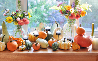 Fall harvest pumpkin and gourds arranged for beautiful seasonal table decor for family Thanksgiving dinner or autumn wedding.