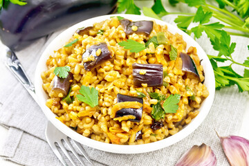 Wall Mural - Bulgur with eggplant in bowl on board