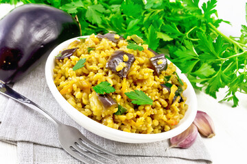 Wall Mural - Bulgur with eggplant in bowl on light board