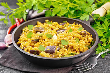 Wall Mural - Bulgur with eggplant in pan on board