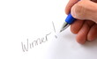 © The Whyte Stock - Pen hand-writes Winner on white paper