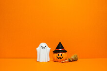 Orange Halloween Background With Ghosts And Pumpkins
