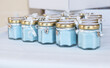 © RooM The Agency - Blue candles in glass jars for a baptism ceremony