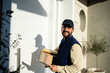 © littlewolf1989 - Portrait of professional delivery man delivering packages to the correct address.