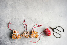 Making Christmas Gingerbread Truck Cookie Ornaments With String And Scissors