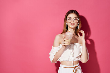 Wall Mural - pretty woman with glasses earrings fashion pink background