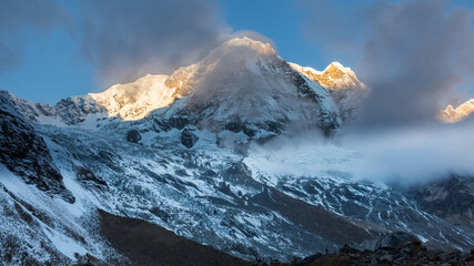 Poster - First sunbeams lighting the peak of Mount Annapurna South on sunrise, Annapurna Base Camp , Annapurna Conservation Area, Himalaya, Nepal.