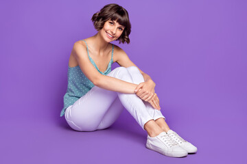 Wall Mural - Portrait of attractive cheerful girl sitting on floor resting spring bargain isolated over bright purple violet color background