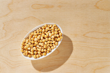 Sticker - Top view of dried chickpeas on wooden background