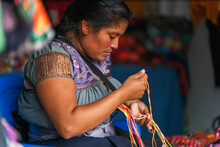 Young Mexican Woman Embroidering Typical Regional Blouses And Shirts