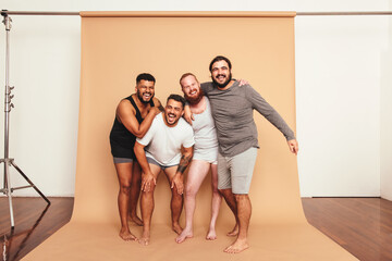 Male friends laughing together in a studio