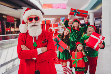 Wall Mural - Portrait of attractive cheerful trendy group elfs folded arms eve advent time buying package having fun at store mall indoors