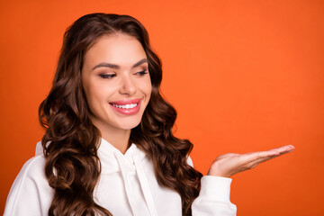 Canvas Print - Photo of young girl good mood look product promo advertise sale isolated over orange color background