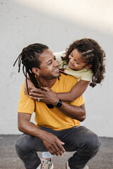 Beautiful portrait of dominican fahter and son smiling and looking at each other