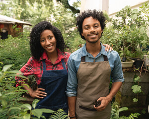 Wall Mural - portrait of couple standing and smiling in the garden