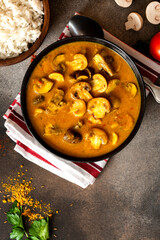 Sticker - Mushroom curry. Homemade spicy mushroom curry in a black bowl on a dark background. Vegan food, Indian cuisine.