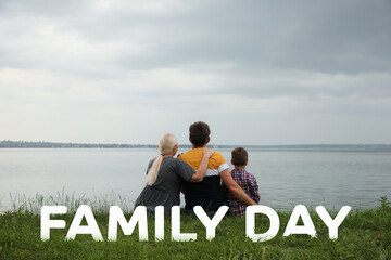 Wall Mural - Little boy and grandparents spending time together near river, back view. Happy Family Day