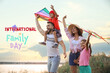© New Africa - Happy parents and their children playing with kites outdoors. Happy Family Day