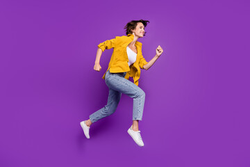 Poster - Full length body size view of nice cheerful motivated girl jumping running isolated over bright violet purple color background