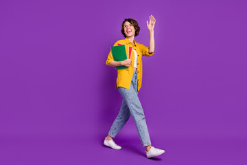 Sticker - Photo of pretty friendly young lady wear yellow shirt spectacles holding copybooks waving arm smiling isolated violet color background