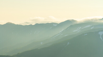 Wall Mural - Fantastic foggy mountain background, morning in mountains