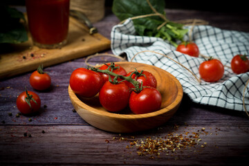 cherry tomatoes and tomato juice on a black background.