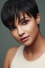 Portrait Of Beautiful Young Woman With Short Hair And And Nice Makeup On Her Face Isolated On Studio Background