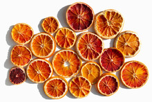 dried red orange slices texture background in sunlight