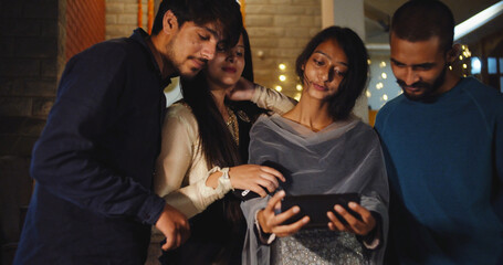 Wall Mural - Young South Asian people from India checking the phone