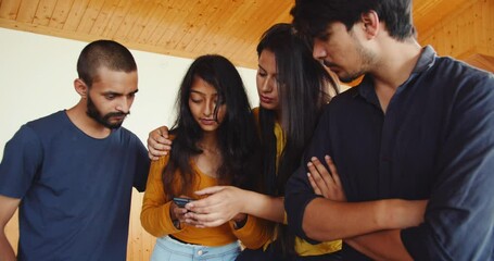 Wall Mural - The young South Asian people from India talking and checking the phone