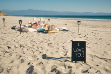 I LOVE YOU Sign On Placard Near Dining Table At Beach Against Clear Blue Sky During Sunny Day, Nayarit, Mexico