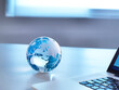 © Andrew Brookes/Westend61 - Global Markets, A glass globe with a laptop