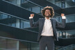 © Hernandez and Sorokina/Westend61 - Excited businessman cheering outside office