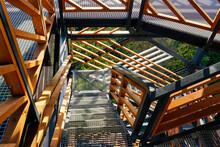 a fragment of the structure of a new modern metal observation tower with decorative wooden elements