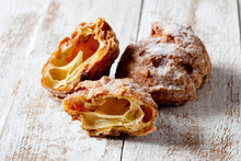 Choux pastry crullers on white wood